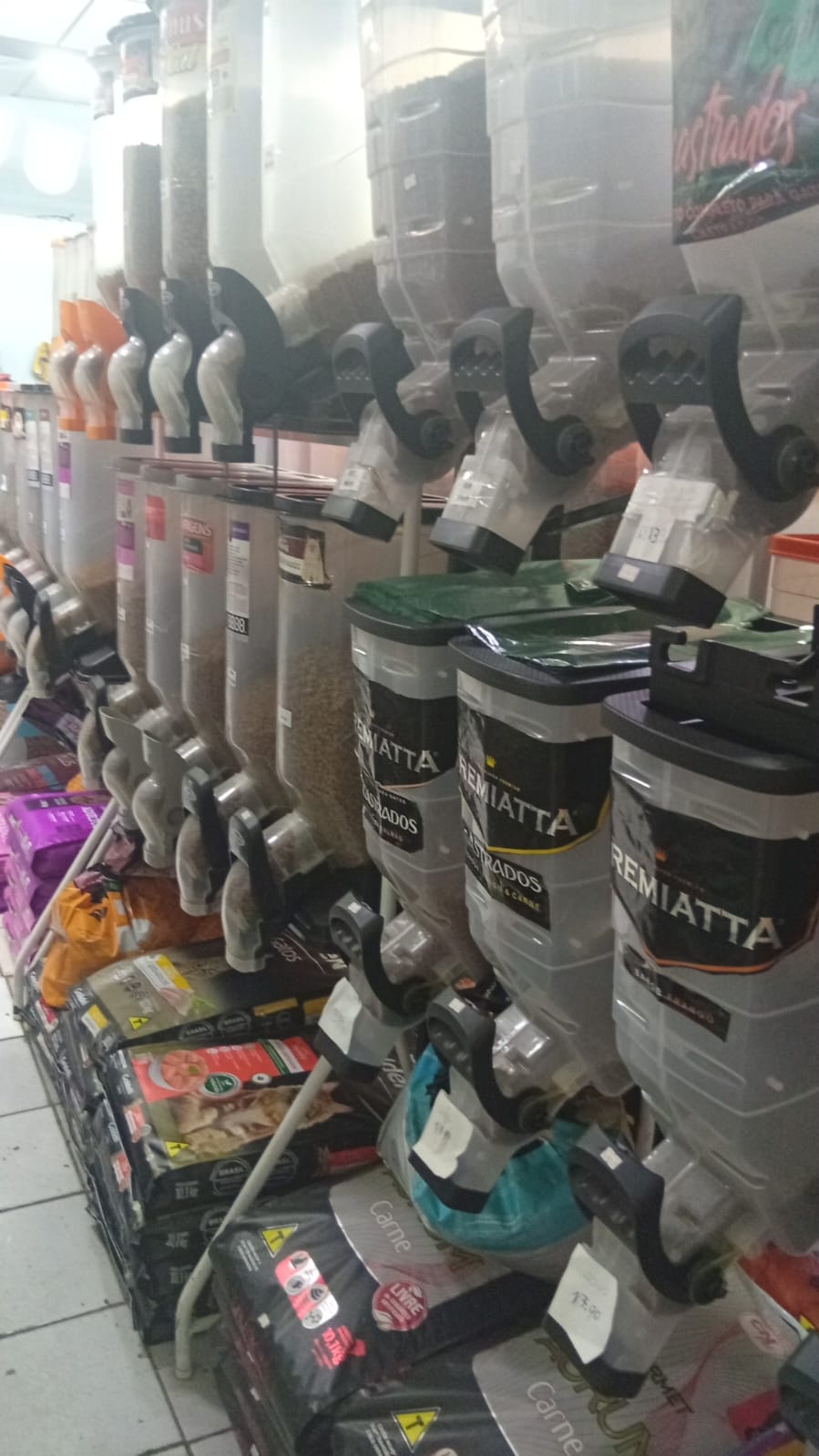 Dispensers de ração premium Remiatta e sacos de ração Premier nas prateleiras.